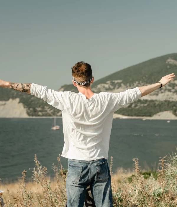 rear-view-man-standing-shore-against-sky-page