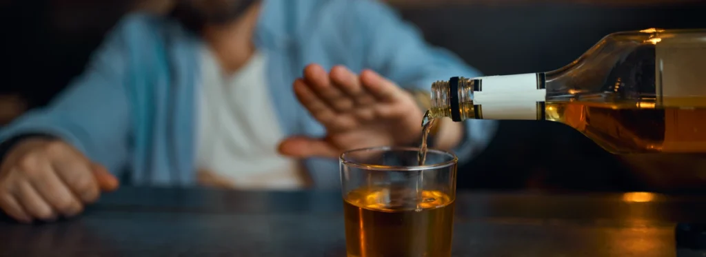 man refusing drink